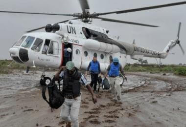 UN officials disembark from a helicopter near the town of Kurtunwaarey in the Lower Shabelle region of Somalia on November 20. The United Nations today conducted an inter-agency assessment mission in the recently liberated town of Kurtunwaarey, as part of an ongoing effort to assess the humanitarian needs of civilians living in former Al-Shabaab controlled areas. UN Photo / Tobin Jones
